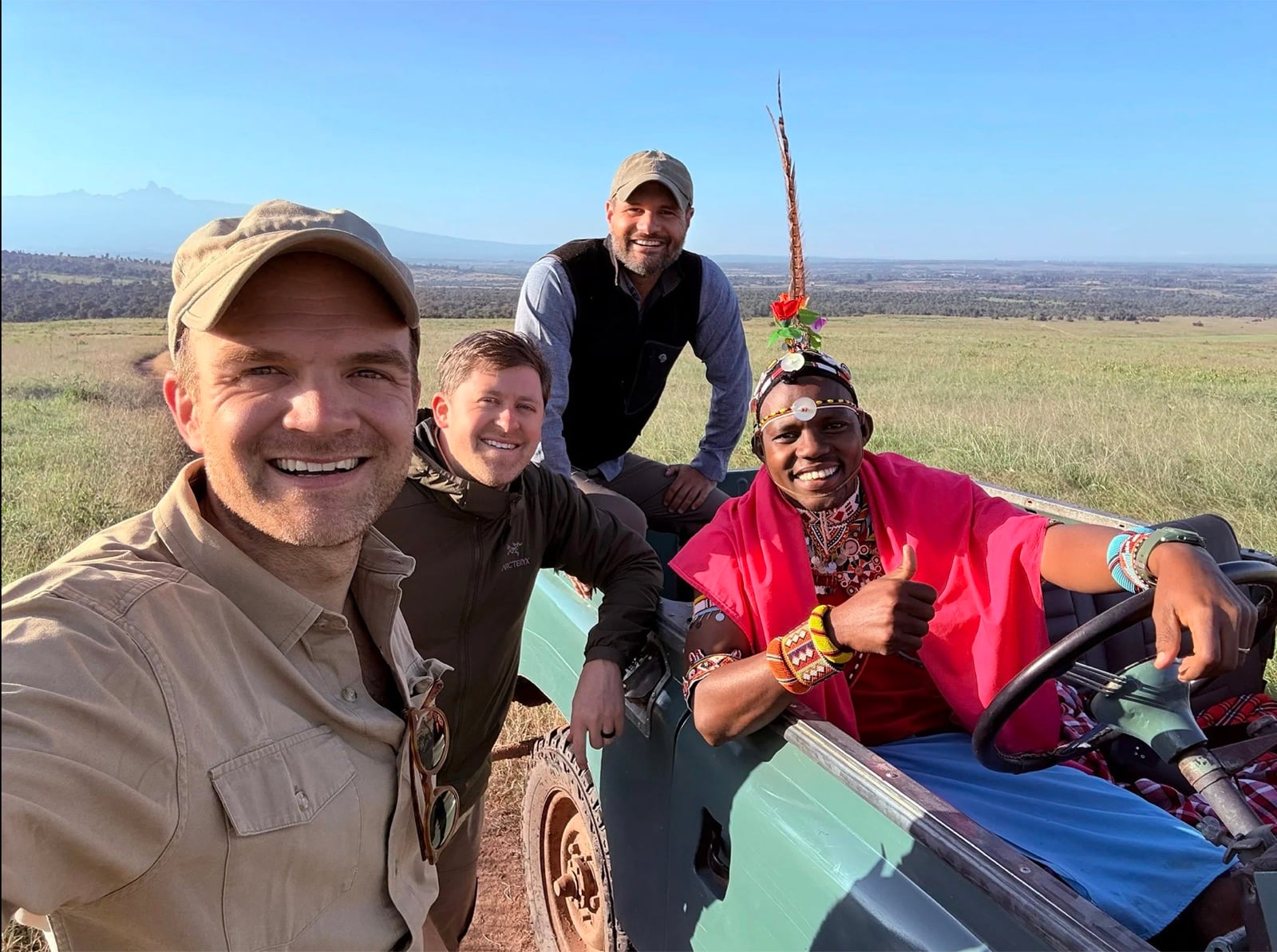 Austin, Taylor, and Bobby with a Maasai guide in the safari cruiser