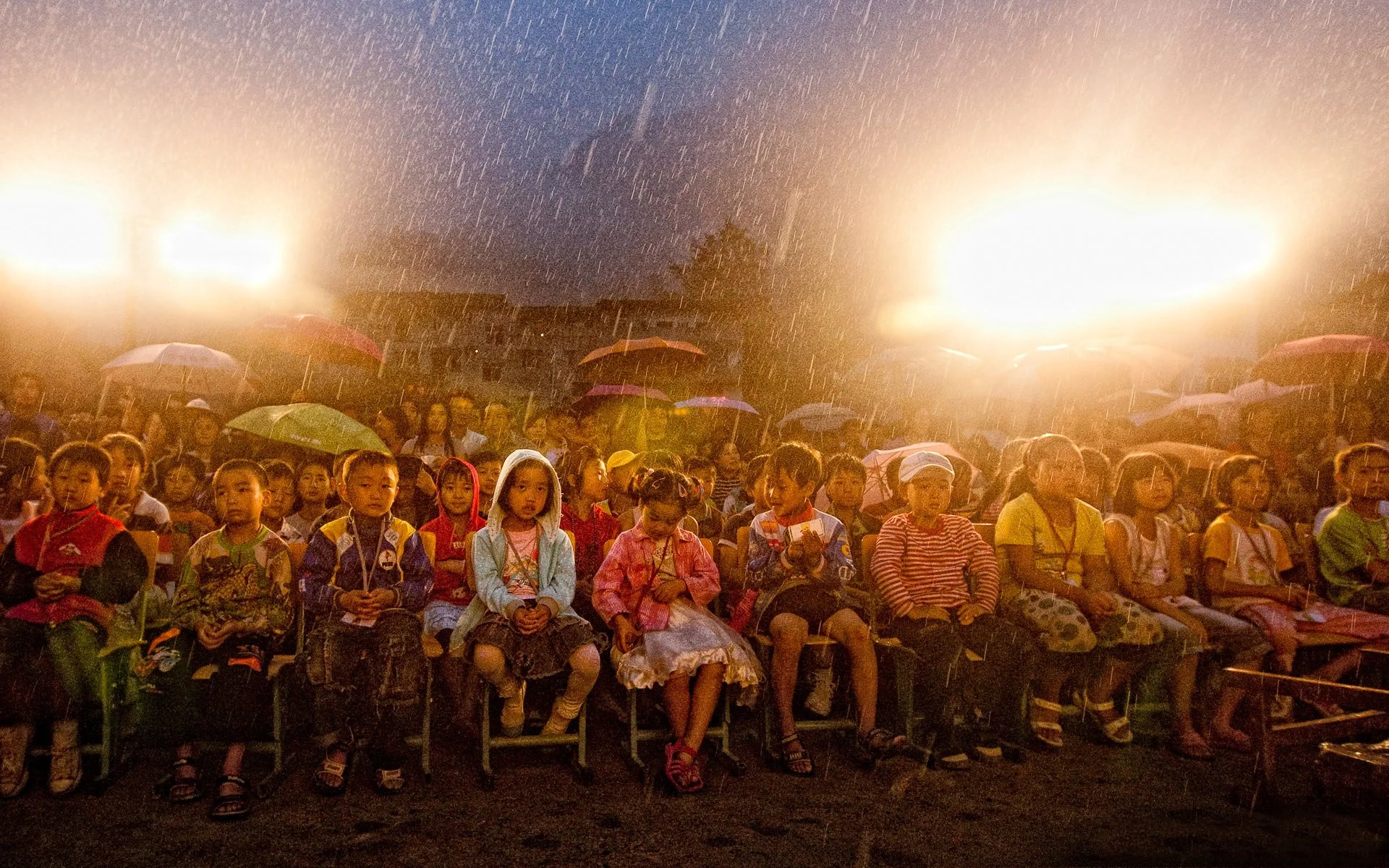 Schoolchildren under umbrellas