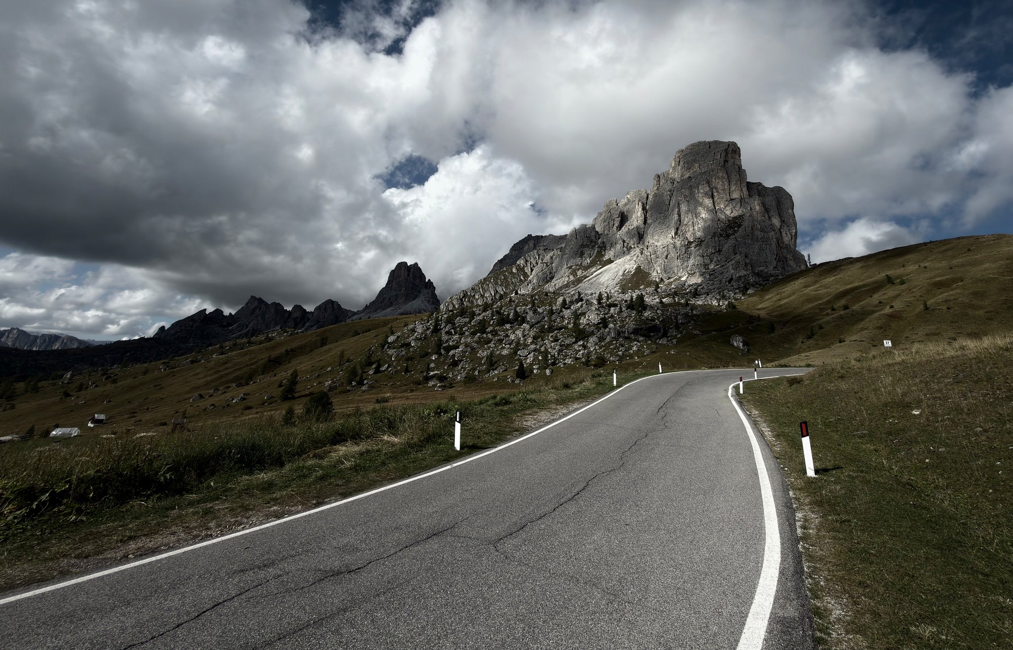 The road curling around the Ra Gusela at Passo Giau under heavy cloud