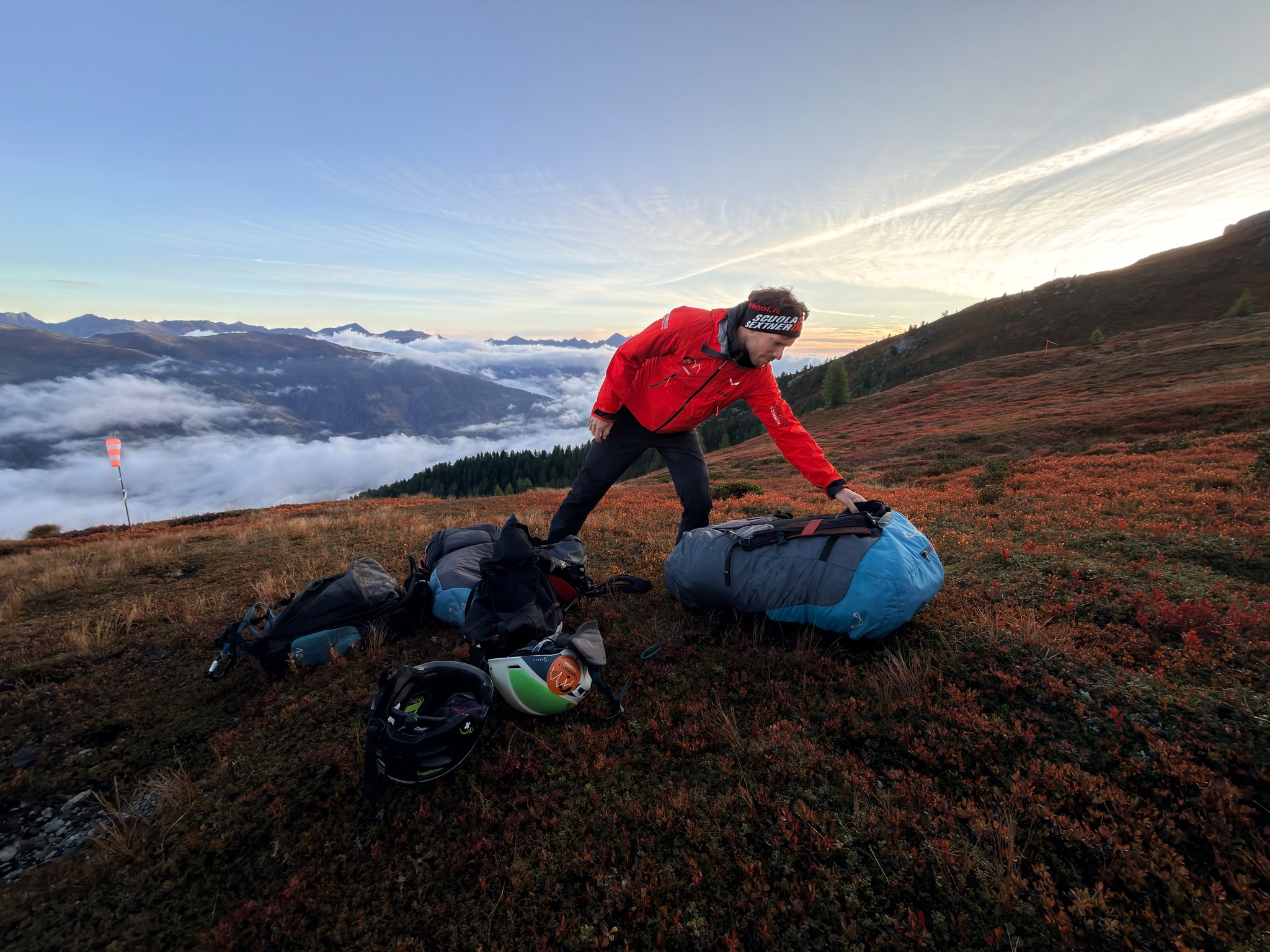 Our tandem pilot laying out the wing at dawn, a sea of cloud filling the valley below
